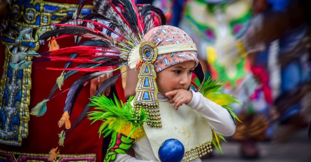 Festival Cultura UNAM reúne ópera, danza y teatro en su cuarta edición Un niño con traje tradicional participa en una festividad cultural vibrante en Atlacomulco, México.