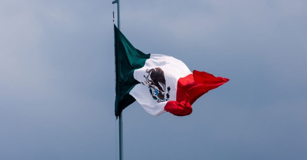 Canaco CDMX prevé derrama de 12 mil 170 millones de pesos por Fiestas Patrias La bandera mexicana ondea majestosamente contra un claro cielo azul en Ciudad de México, México.